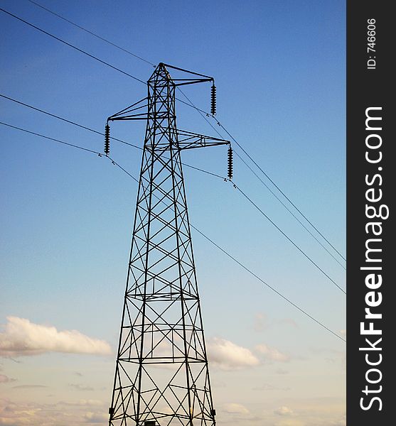 An electricity pylon carries power across the land. An electricity pylon carries power across the land