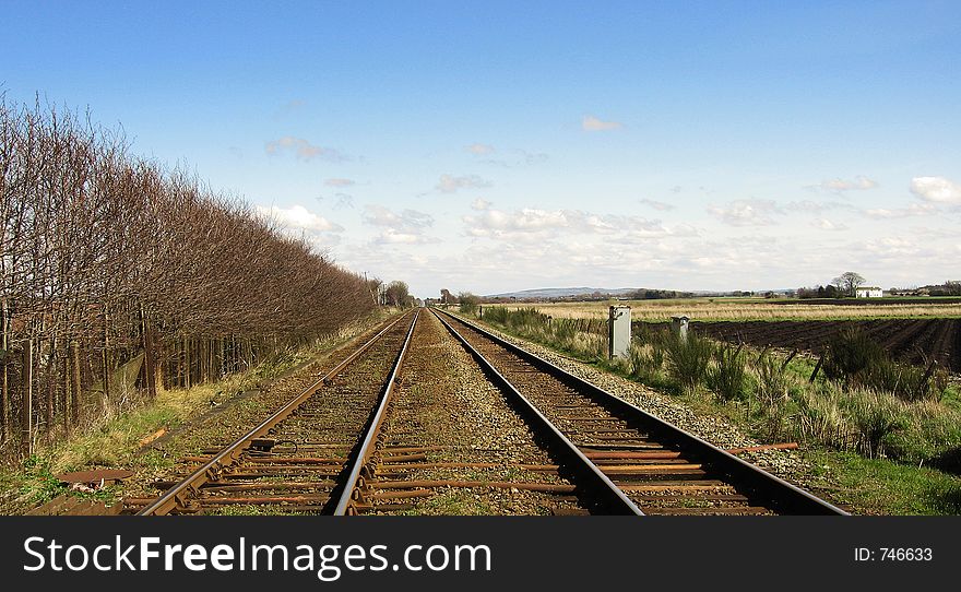 A long stretch of European rail track. A long stretch of European rail track