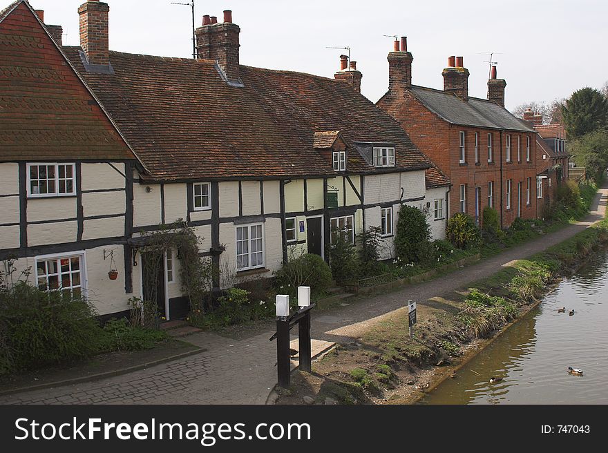 Cottages next to canal on sunny day