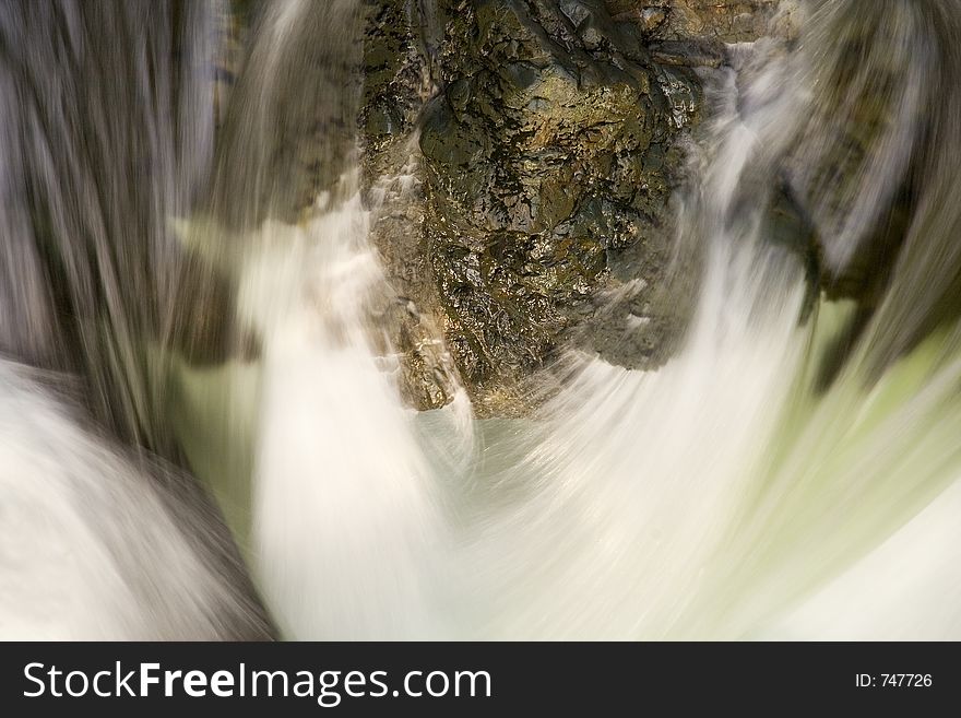 Water abstract with sharp rock and smooth flowing water