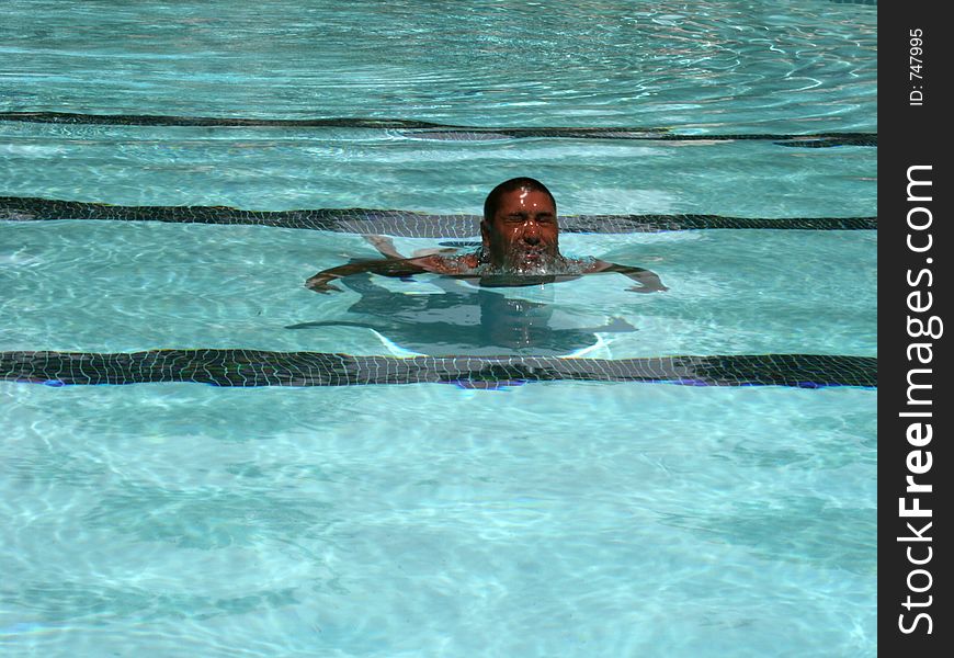 Man at the pool coming out of the water. Man at the pool coming out of the water