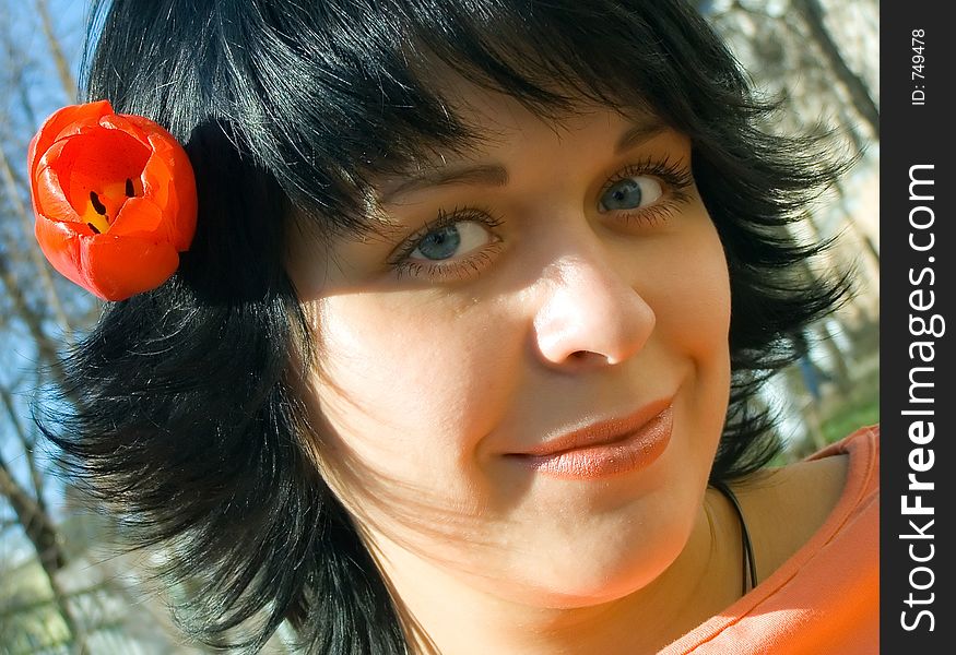 The beautiful girl with a flower in hair