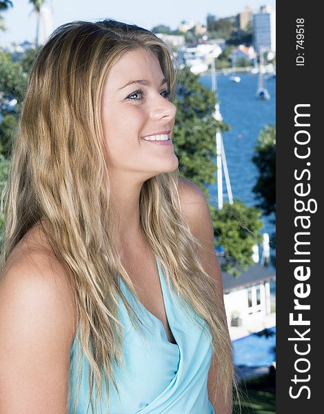 Blonde portrait in blue dress on the balcony