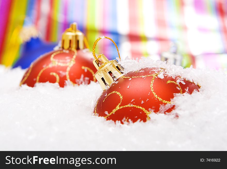 Christmas balls with snow on color background