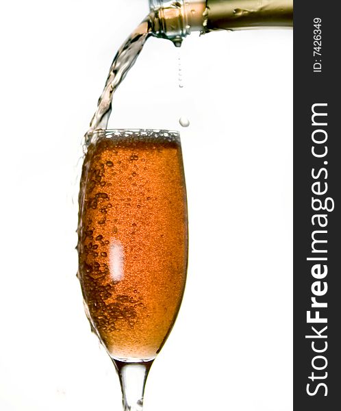 Pouring champagne in glass isolated on white