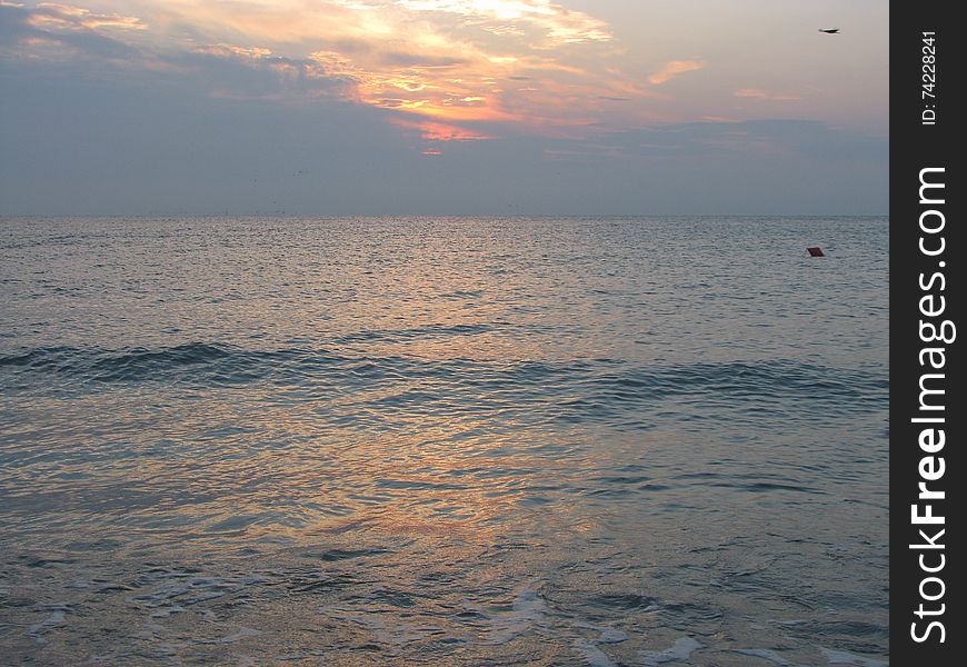 View of the beautiful and calm sea, at sunrise. View of the beautiful and calm sea, at sunrise.