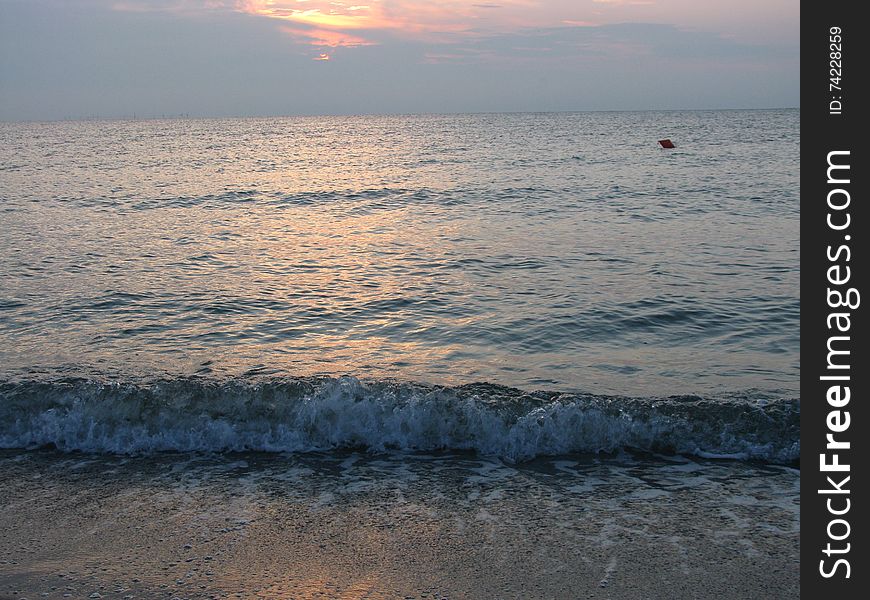 View of the beautiful and calm sea, at sunrise. View of the beautiful and calm sea, at sunrise.