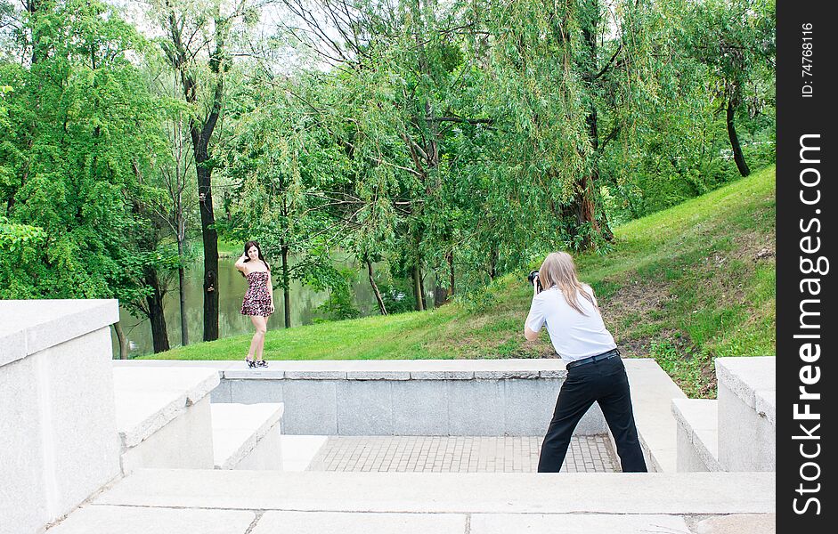 Photographer Takes A Woman Standing On The Stairs In The Park