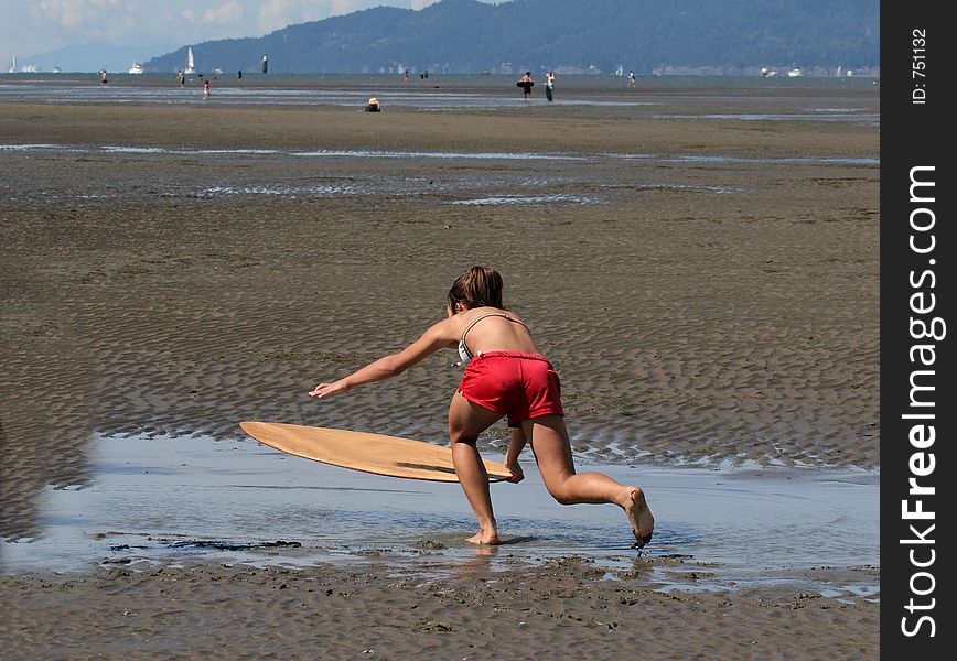 Young girl sand surfing. Young girl sand surfing