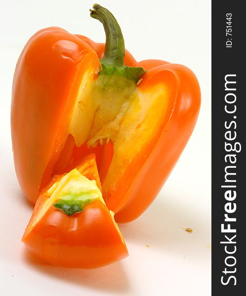 Colorful orange capsicum in front of a white background. Colorful orange capsicum in front of a white background