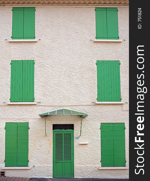 A house with its green blinds closed. A house with its green blinds closed.