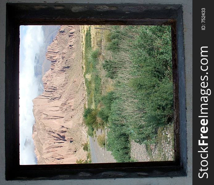 A mountain range as seen through a window. A mountain range as seen through a window