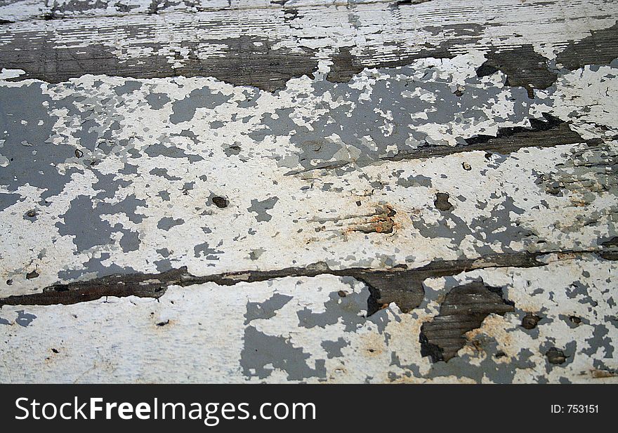 Close up of a wooden bench that sits on the front porch of a historical home. Peeling, crazed, crackled paint. Close up of a wooden bench that sits on the front porch of a historical home. Peeling, crazed, crackled paint.