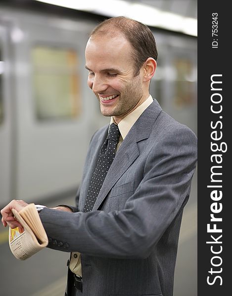 Businessman in front of a train watching his clock. Businessman in front of a train watching his clock
