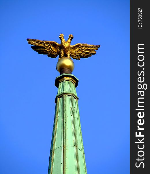 Statue of an eagle on a sharp point architectural building