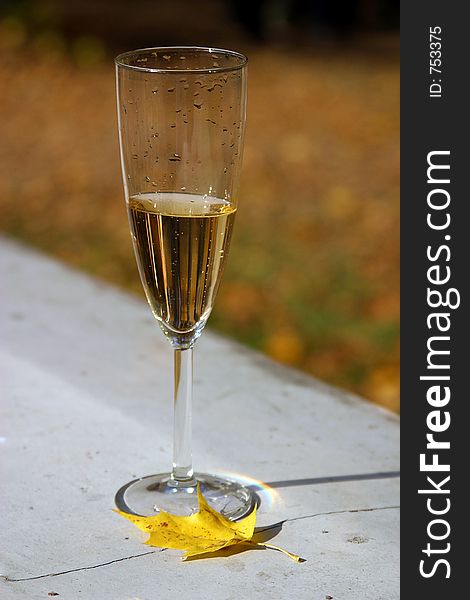 Glass worth on the concrete plate, filled with champagne. Glass worth on the concrete plate, filled with champagne