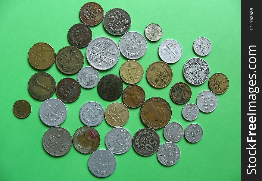 Many difference old coins on green background... obverse side Polish,German,Hungarian,Austrian,Czech&Slovakia,Russian(CCCP),Dutch coins. Many difference old coins on green background... obverse side Polish,German,Hungarian,Austrian,Czech&Slovakia,Russian(CCCP),Dutch coins