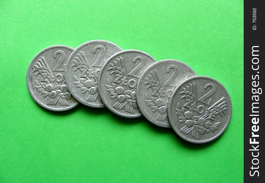 Five old Polish coins on green background... obverse side...