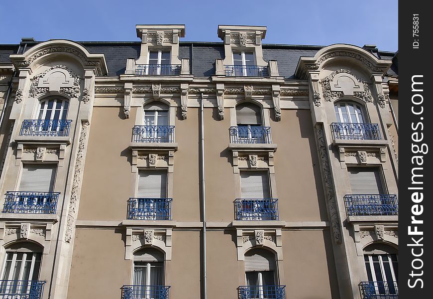 House facade in France in front of blue sky