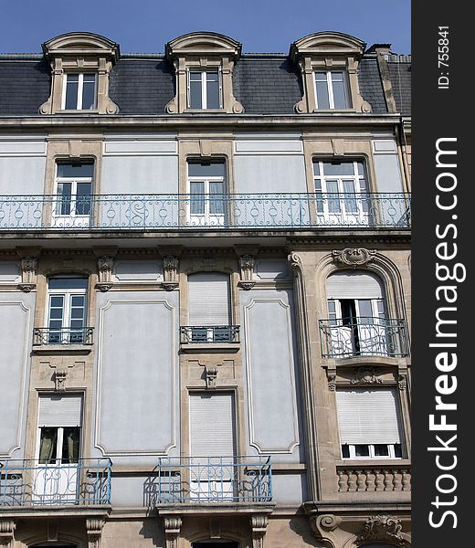 House facade in France in front of blue sky