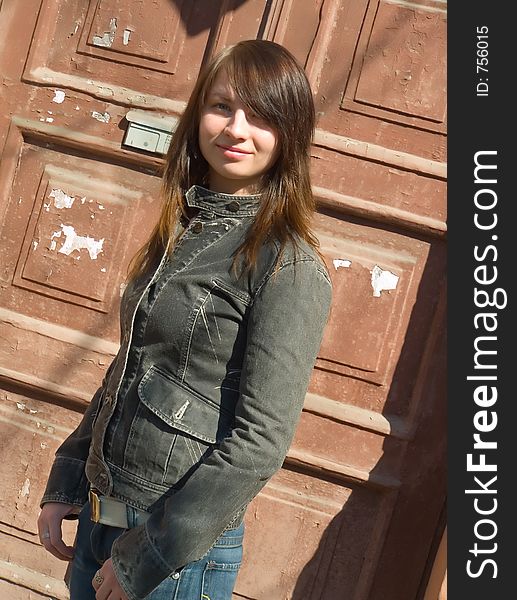 The girl on a background of an old door. The girl on a background of an old door