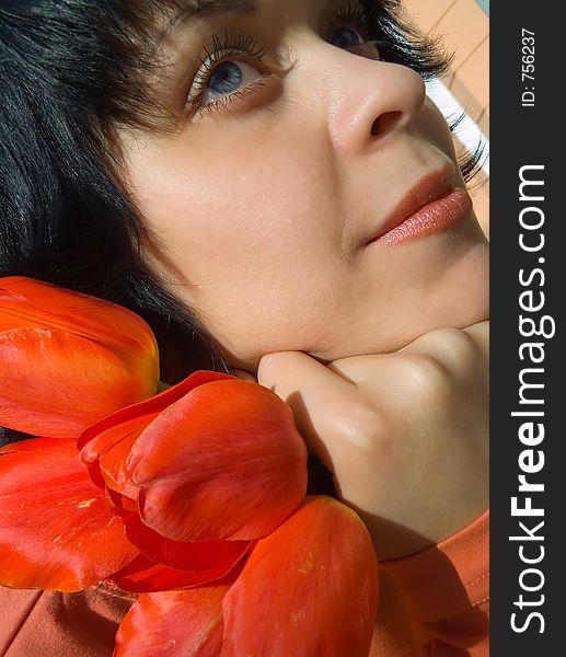 The girl and a bouquet of tulips. The girl and a bouquet of tulips