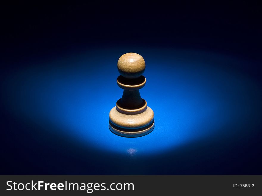Wooden pawn chess piece with light from top. Wooden pawn chess piece with light from top