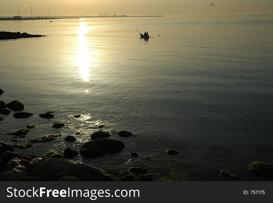 Fishing at sunrise in a bay in italy. Fishing at sunrise in a bay in italy