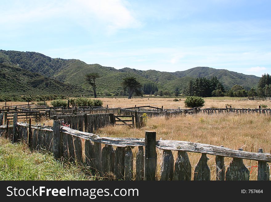 Hay fields and neglected fencing on a New Zealand farm.