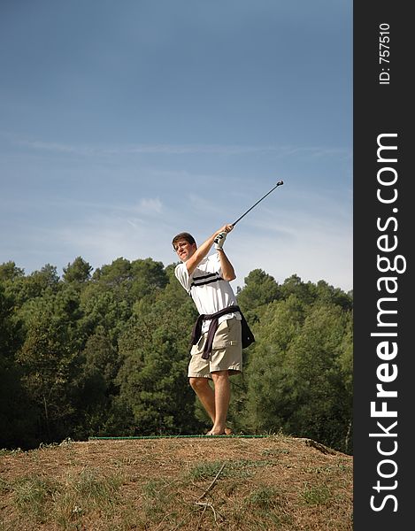 Man playing golf in a sunny day. Man playing golf in a sunny day