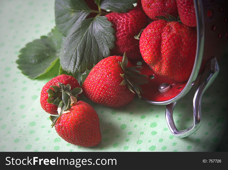 Strawberries falling out of colander