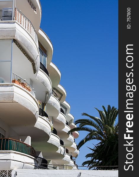 Apartment complex balconies overlook palm trees. Apartment complex balconies overlook palm trees