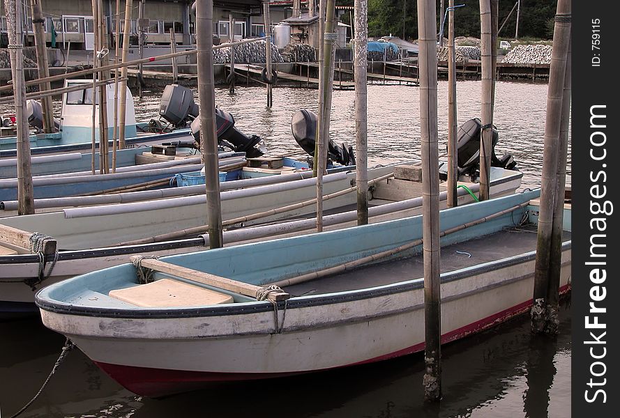 Dusk view with boats in a fishing pier. Dusk view with boats in a fishing pier.