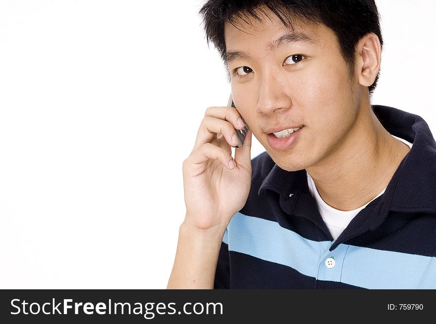 A young chinese male on the phone on white background. A young chinese male on the phone on white background