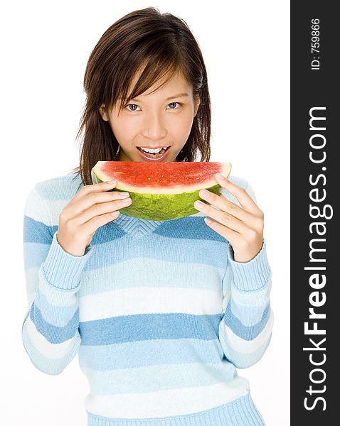 A cute young woman eats a big slice of watermelon. A cute young woman eats a big slice of watermelon