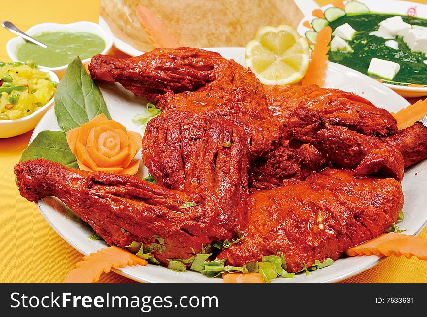 An india chicken on a yellow table