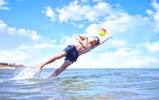 Boy Playing Ball In The Sea Stock Images Boy Playing Ball In The Sea Stock Images