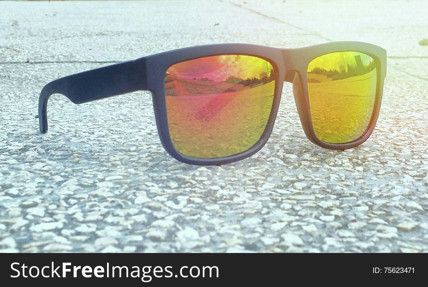 Picture with fashionable colorful sunglases in a sunny day of summer and beautiful landscape on the lake