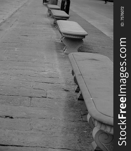 A suggestive monochrome of a row of benches in Florence. A suggestive monochrome of a row of benches in Florence