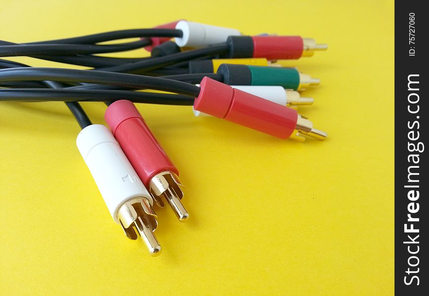 Picture with rca audio video communication cable isolated on a yellow background. Picture with rca audio video communication cable isolated on a yellow background