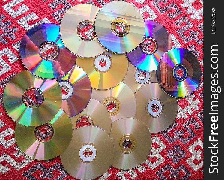 Colorful computer compact disks equipment on the table. Colorful computer compact disks equipment on the table