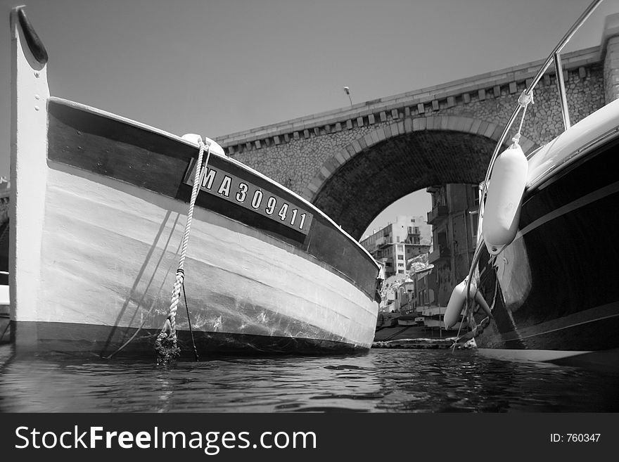 Black and white image of boats moored taken with an underwater camera,