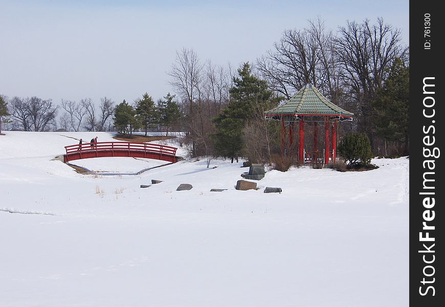 This image depicts a Chinese pagoda and a bridge in the winter season. This image depicts a Chinese pagoda and a bridge in the winter season.
