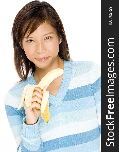 A cute young asian woman with a peeled banana. A cute young asian woman with a peeled banana