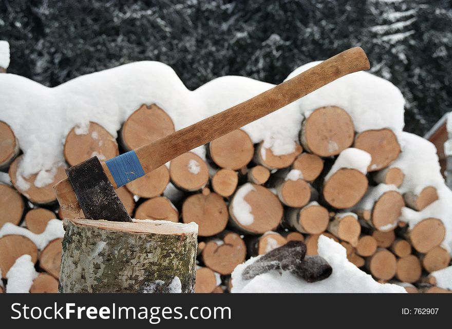 Axe and firewood. Winter