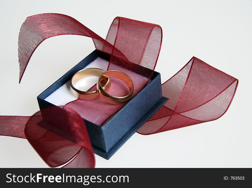 Picture of golden rings in blue box. Picture of golden rings in blue box