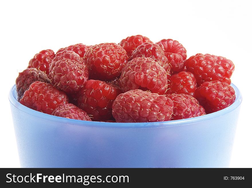 Fresh raspberries in blue glass