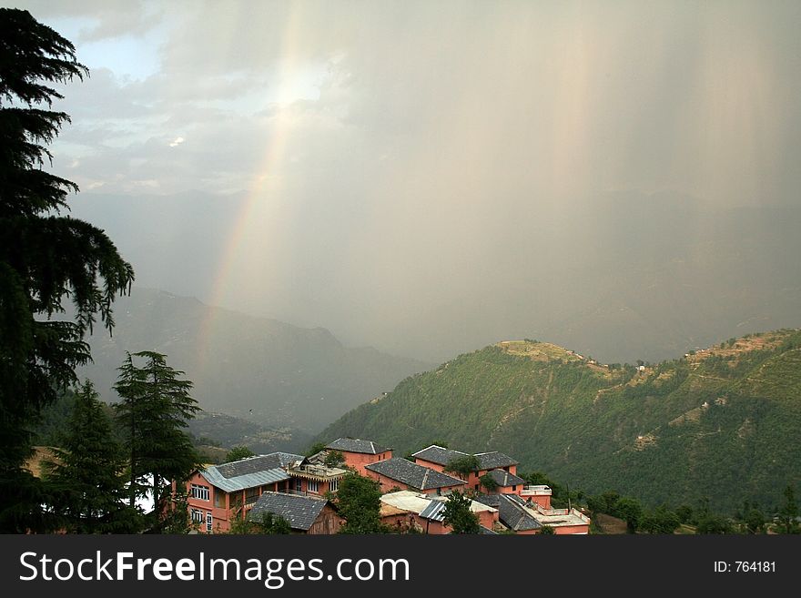 Rainbow and himalayan dwelling in Khajjiar in himalayan India as well as the phenomenon of Virga and dry lightning thunderstorm in the atmosphere. Rainbow and himalayan dwelling in Khajjiar in himalayan India as well as the phenomenon of Virga and dry lightning thunderstorm in the atmosphere