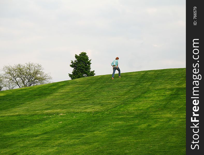 Young fit girl walking up hill