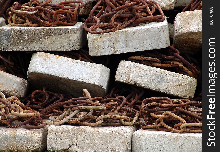 Close up view of chains and concrete bricks in the harbour of Norderney island Germany. Close up view of chains and concrete bricks in the harbour of Norderney island Germany